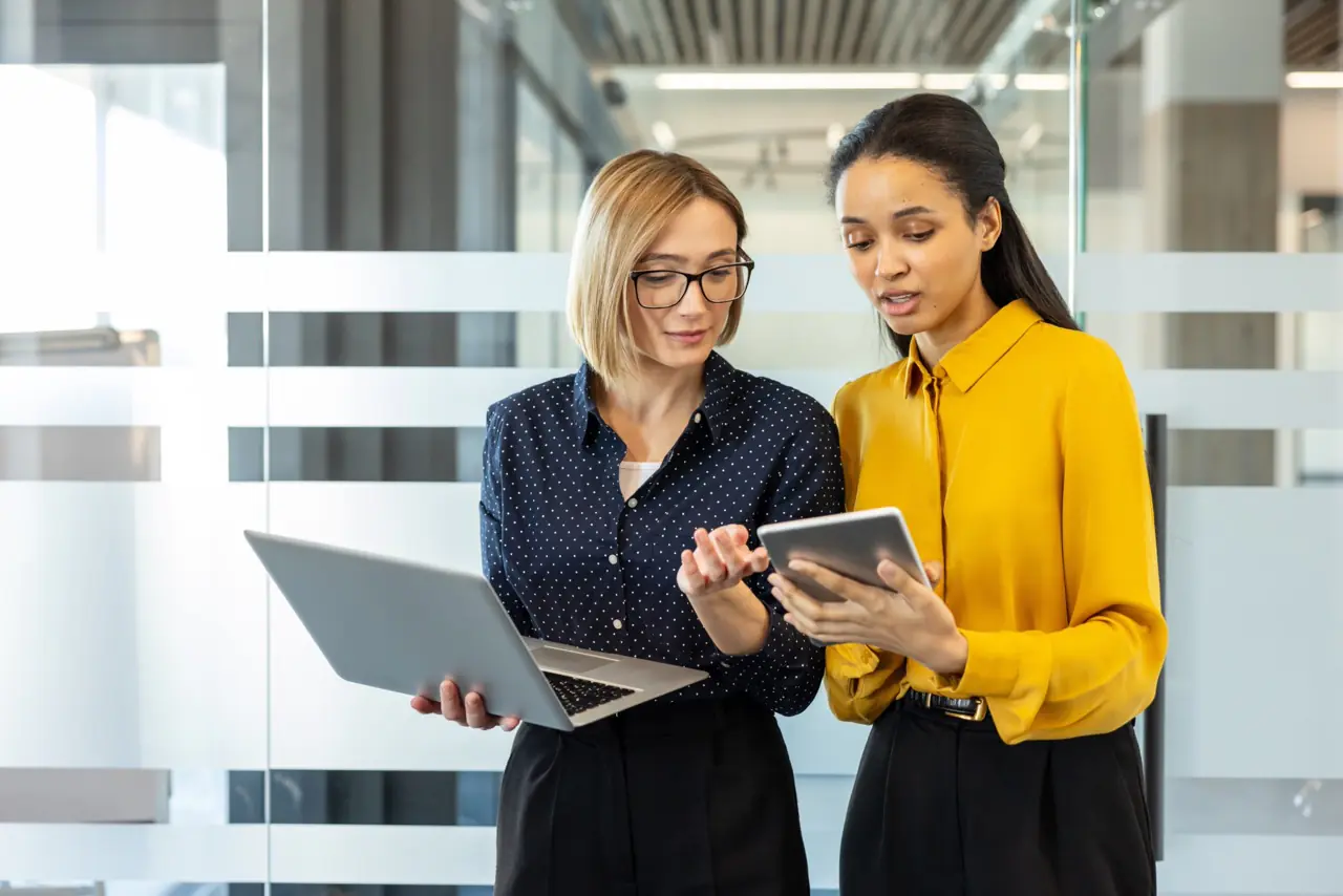 Healthcare IT operations team reviewing Faxination cloud fax transmission queue management and load balancing dashboard during open enrollment peak volume processing period