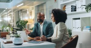 Business professionals reviewing a fax vendor security assessment together on a laptop
