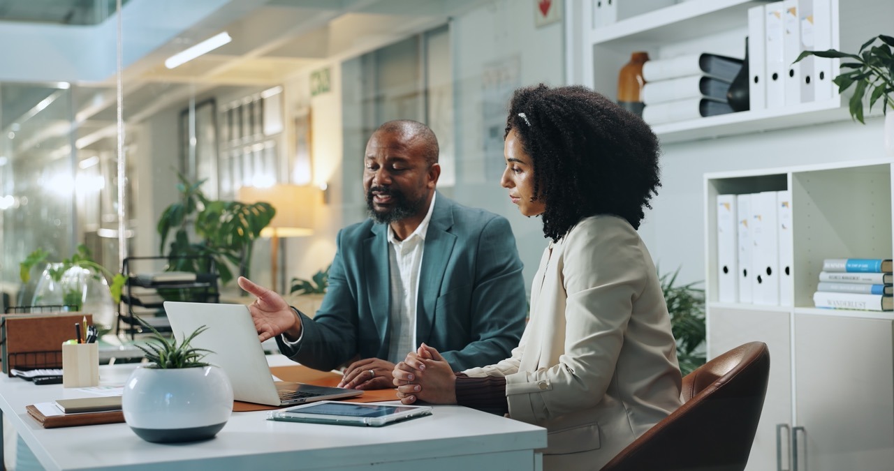 Business professionals reviewing a fax vendor security assessment together on a laptop