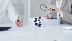 Auditors reviewing compliance documents, illustrating fax audit readiness