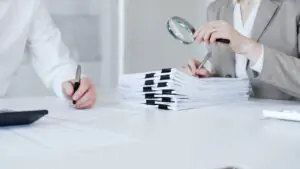 Auditors reviewing compliance documents, illustrating fax audit readiness