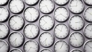 Wall of clocks set to different world time zones, representing global fax infrastructure